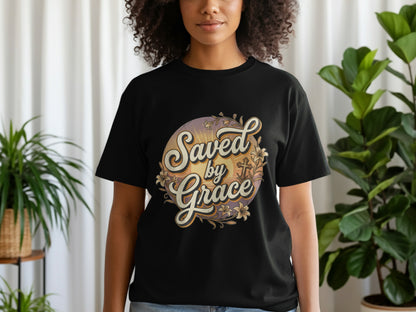Black t-shirt with "Saved by Grace" text, cross, and floral design.