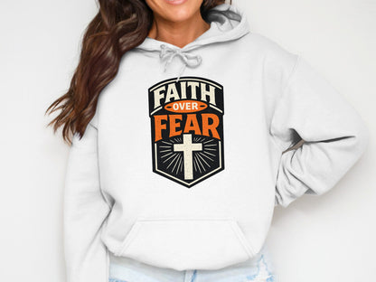 White hoodie with "Faith Over Fear" text and cross graphic.