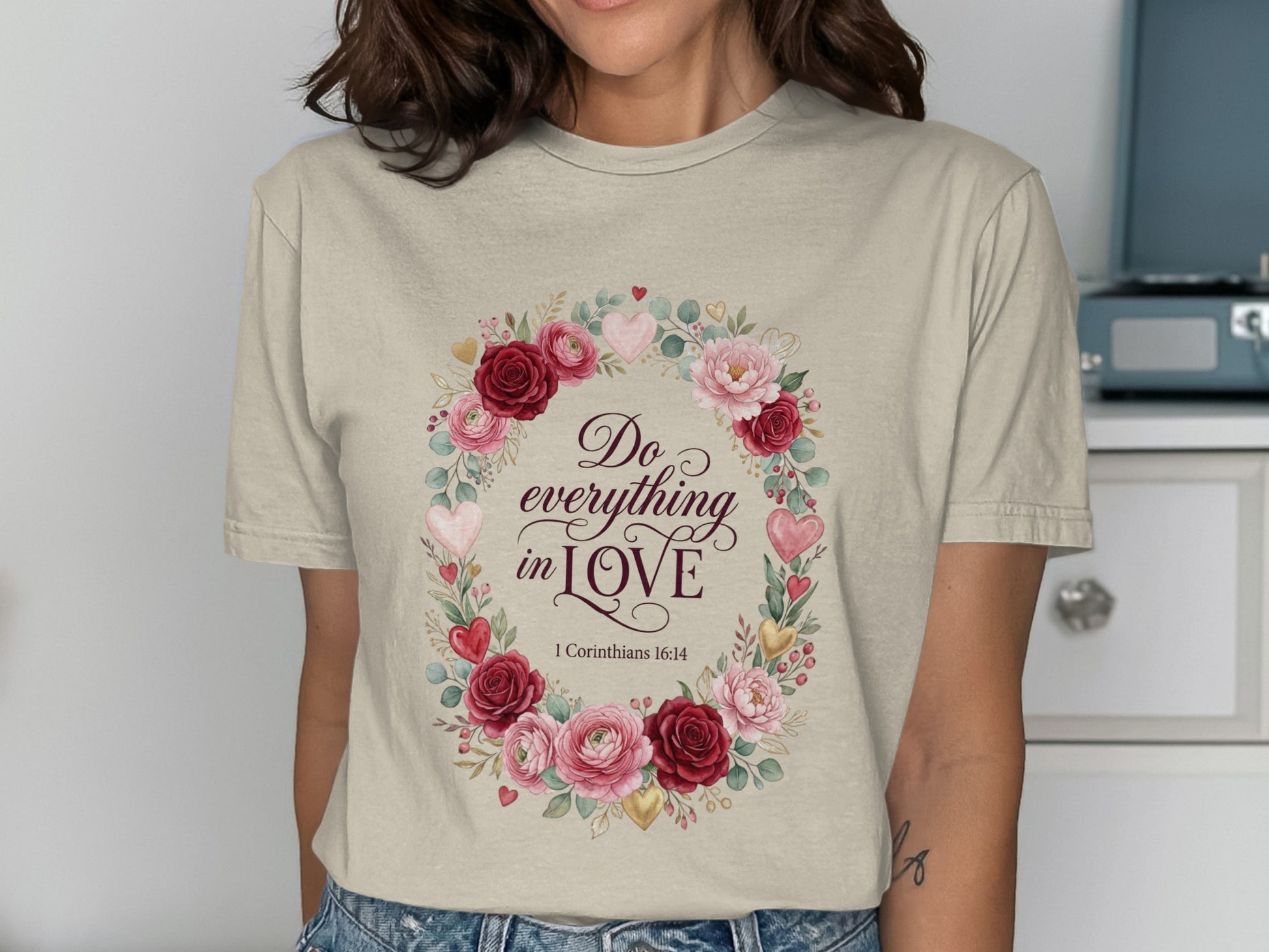 Cream t-shirt with floral wreath and "Do everything in love" text.