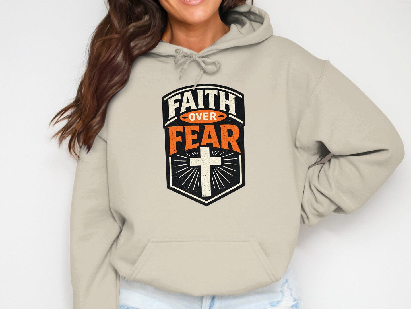 Beige hoodie with "FAITH OVER FEAR" text and cross design.