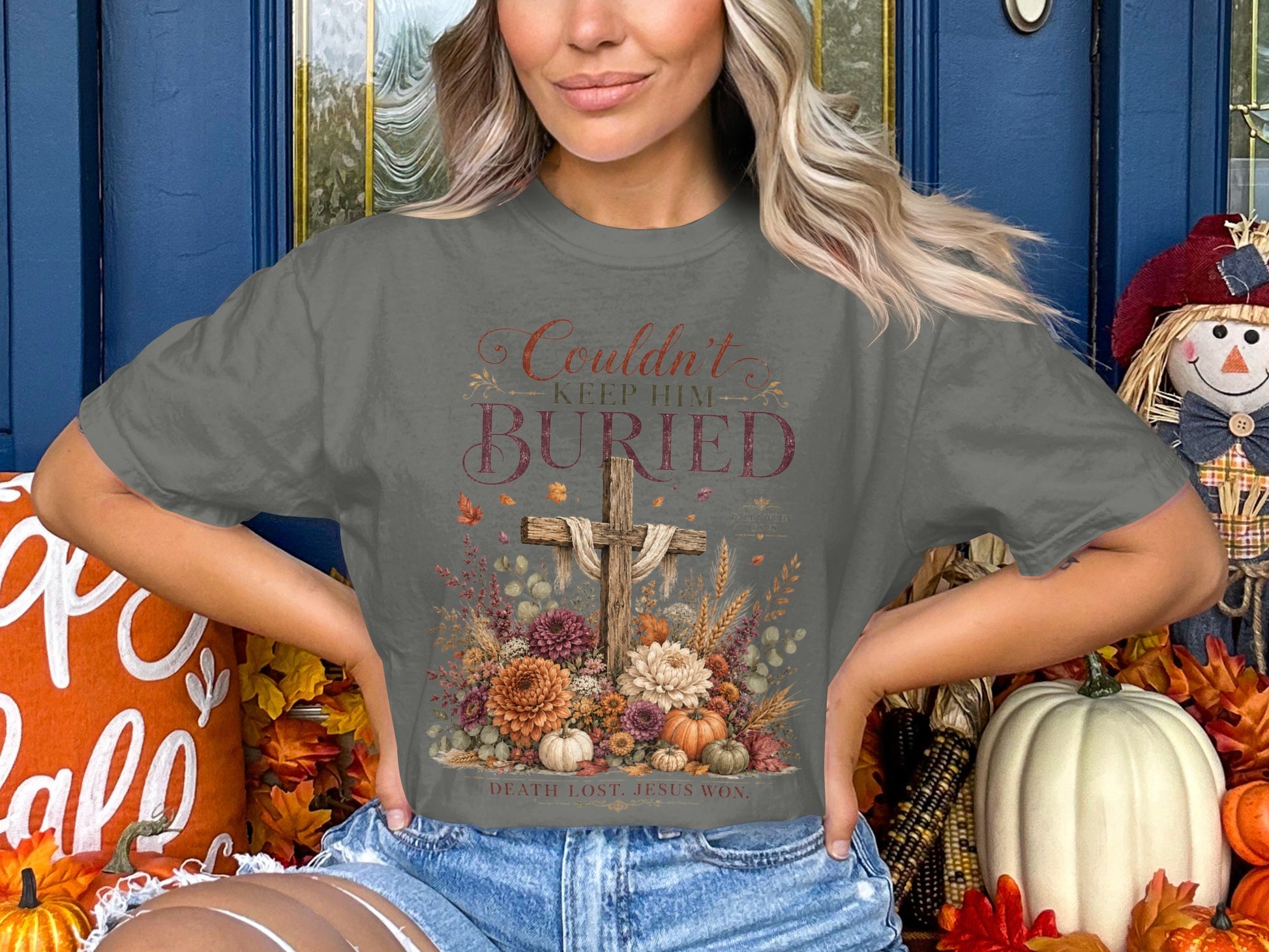 Christian graphic tee with "Couldn't Keep Him Buried" and "Death Lost. Jesus Won." text.