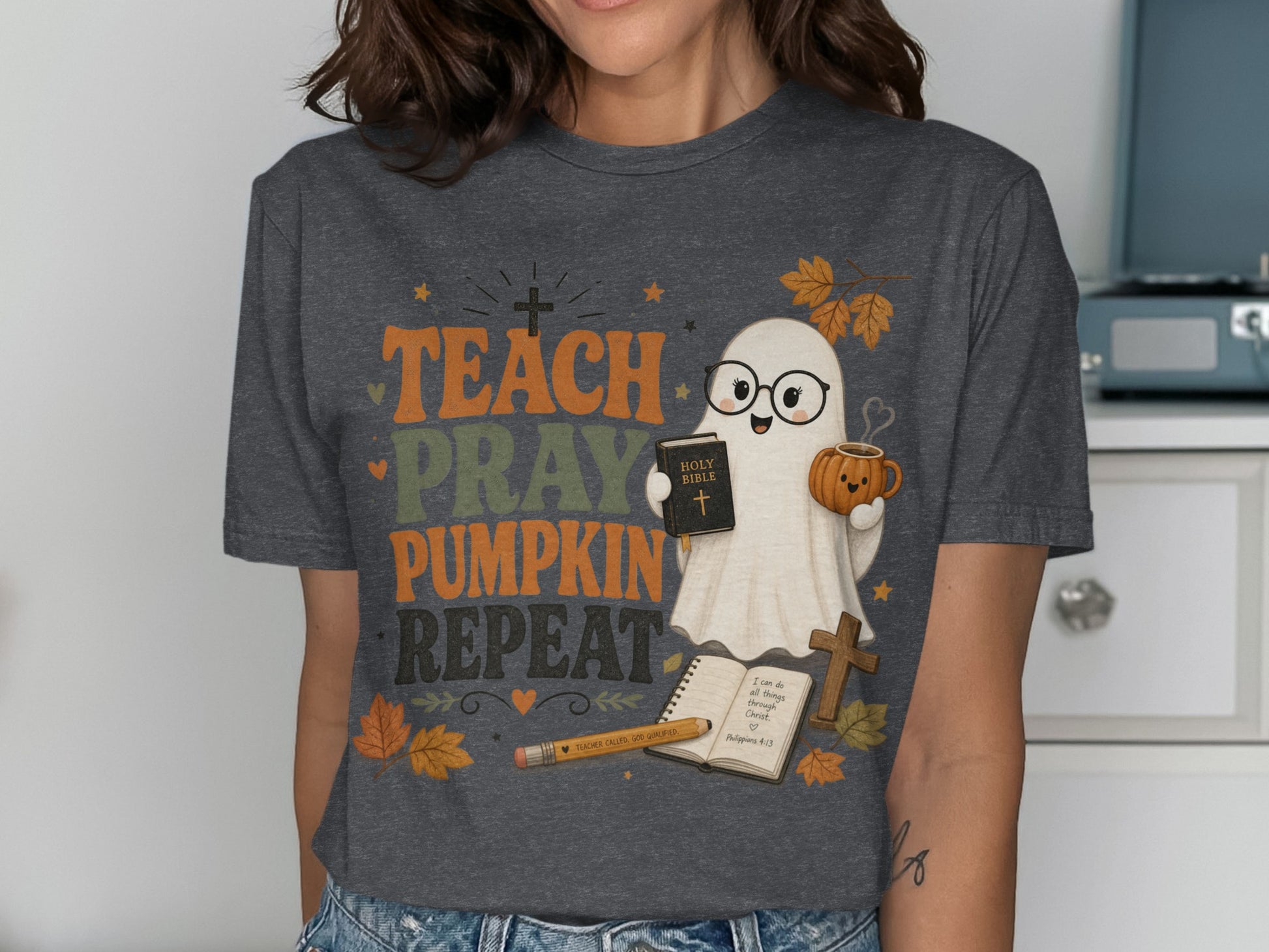 T-shirt with "Teach Pray Pumpkin Repeat" text, a ghost holding a Bible and pumpkin mug.