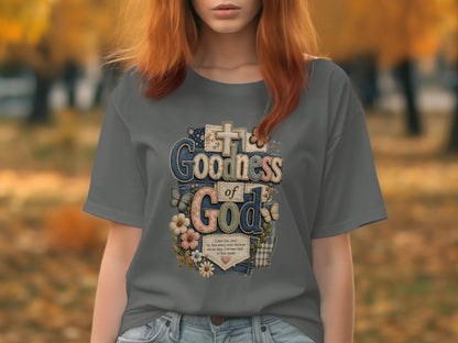 T-shirt with "Goodness of God" text and floral and butterfly embellishments.