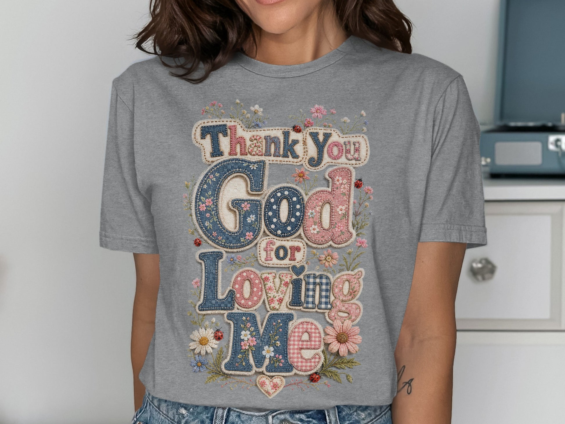 Thank You God for Loving Me text on a grey t-shirt.