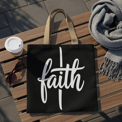 Black tote bag with white script text "faith" displayed centrally.