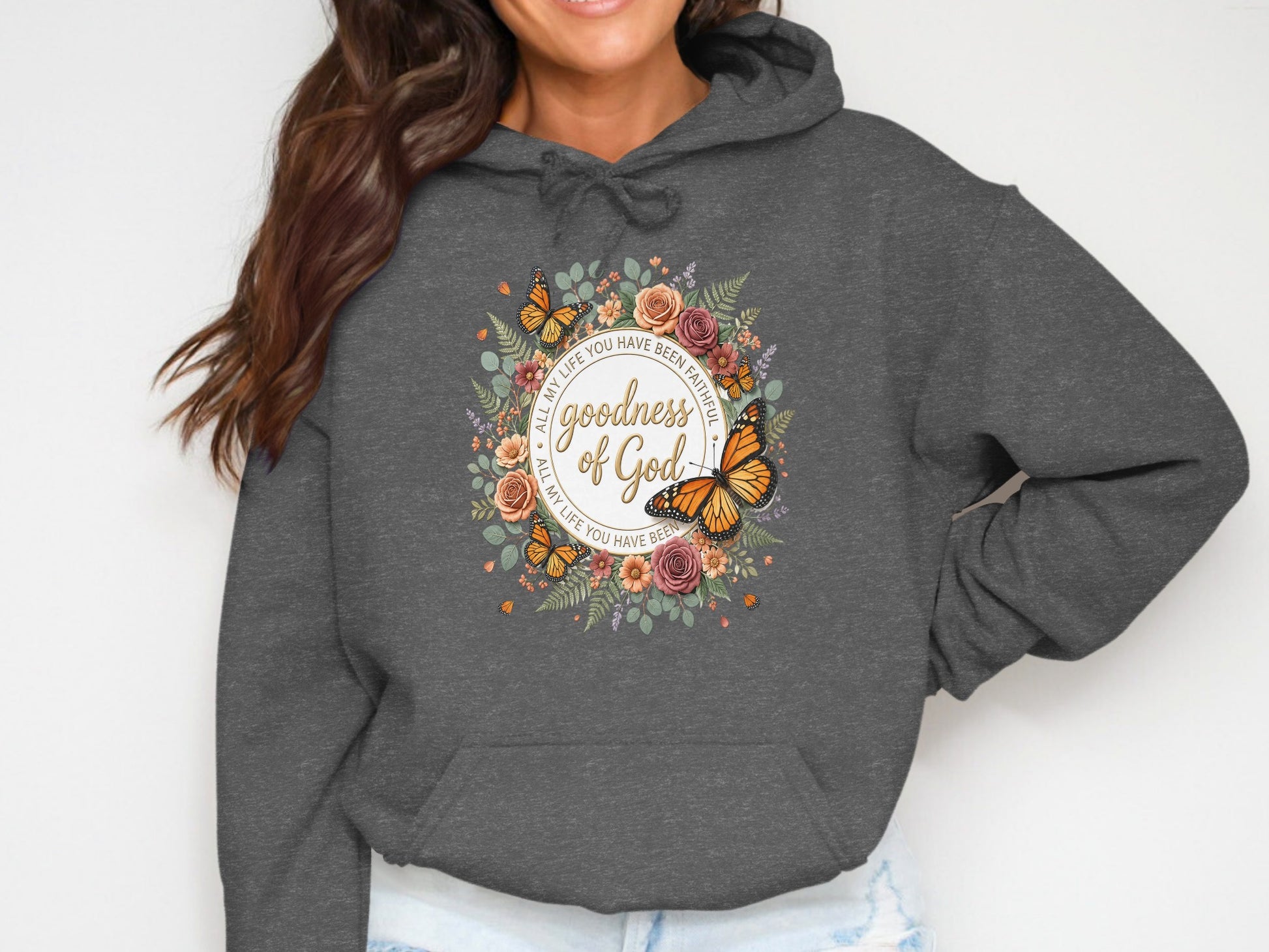 Dark gray hoodie with floral circle featuring butterflies and text.