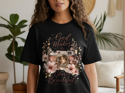 Black t-shirt featuring a floral camera design with text "God Makes the Blurry Beautiful."