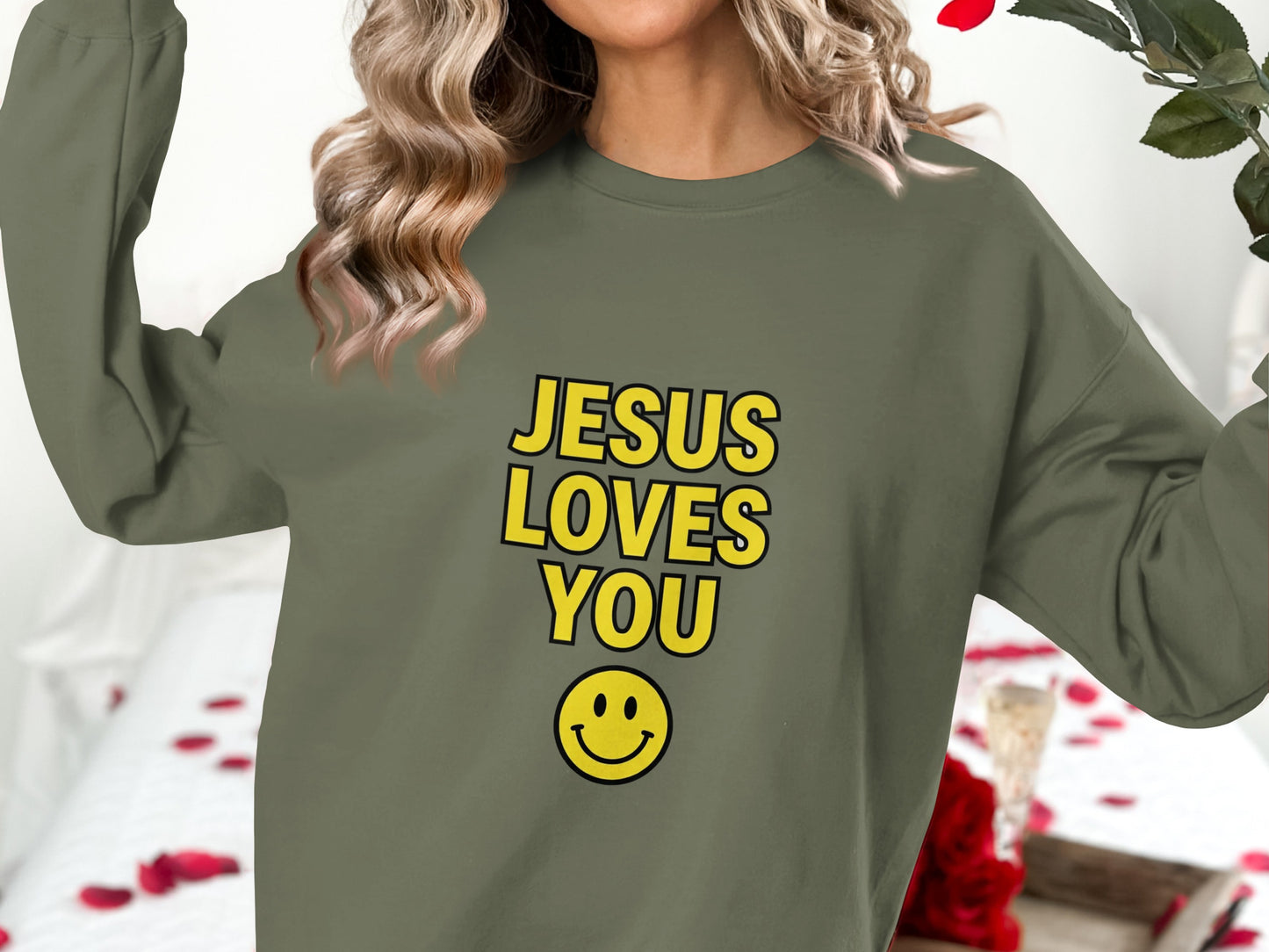 Olive green sweatshirt with "Jesus Loves You" and smiley face graphic.