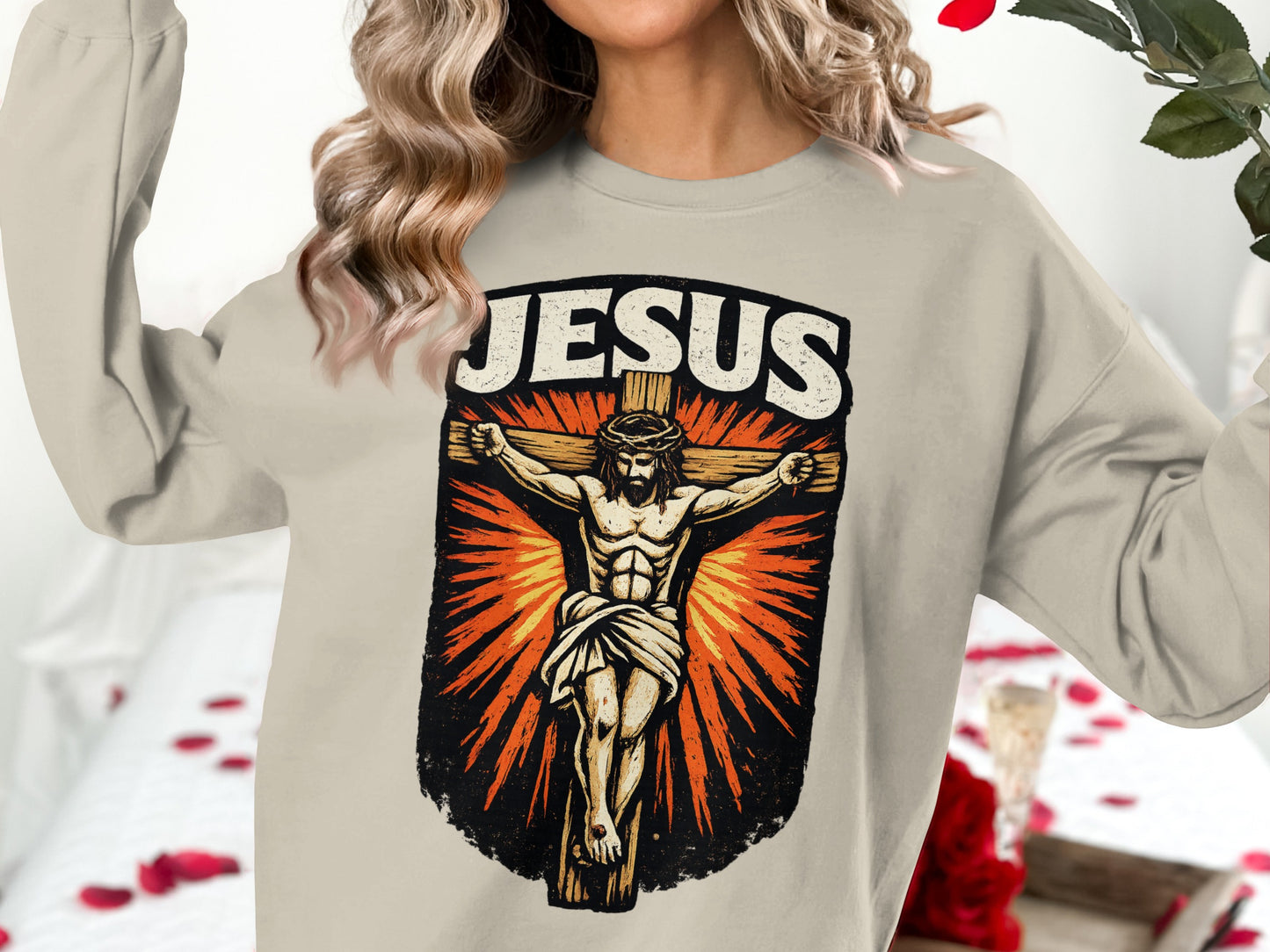 Jesus Christ crucifixion graphic on a light-colored crewneck sweatshirt.