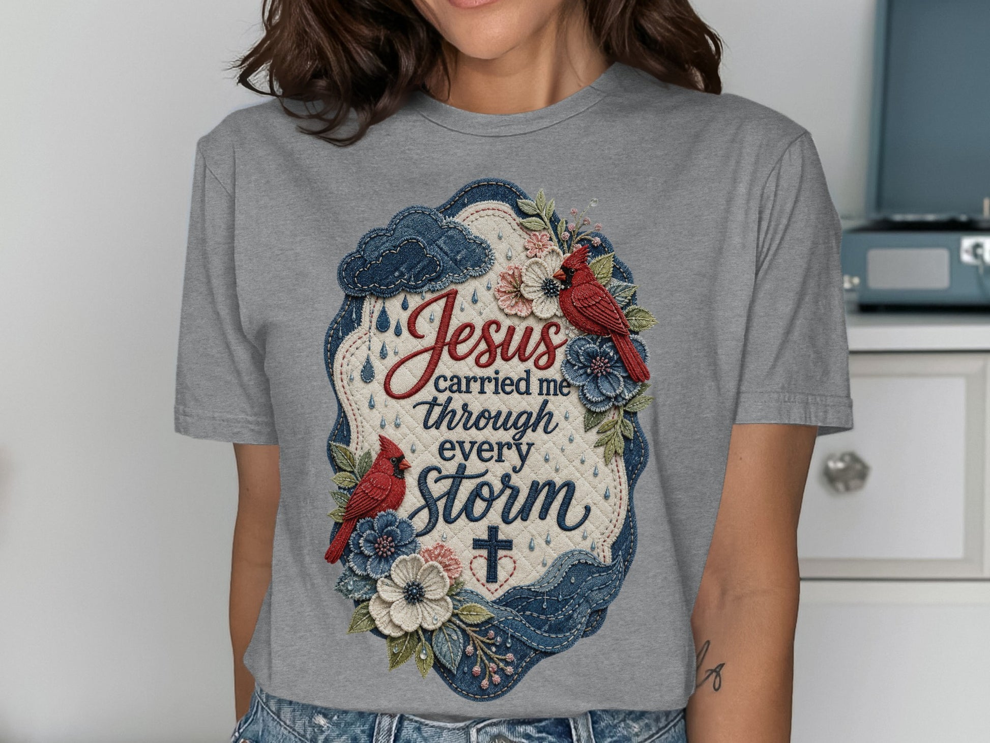 Jesus carried me through every storm text and floral cross design on gray t-shirt.