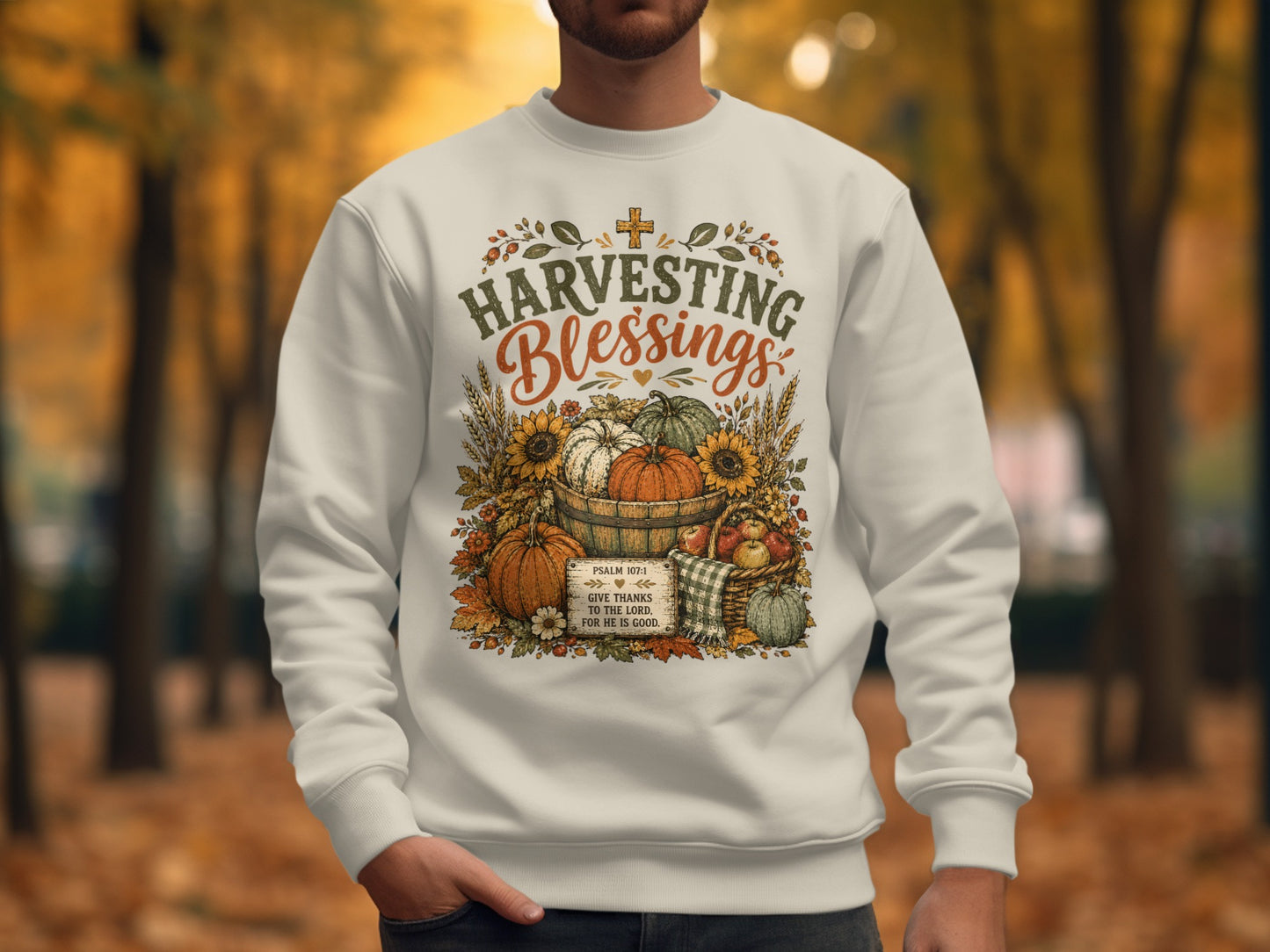 Cream sweatshirt with "Harvesting Blessings" text and autumn graphics.