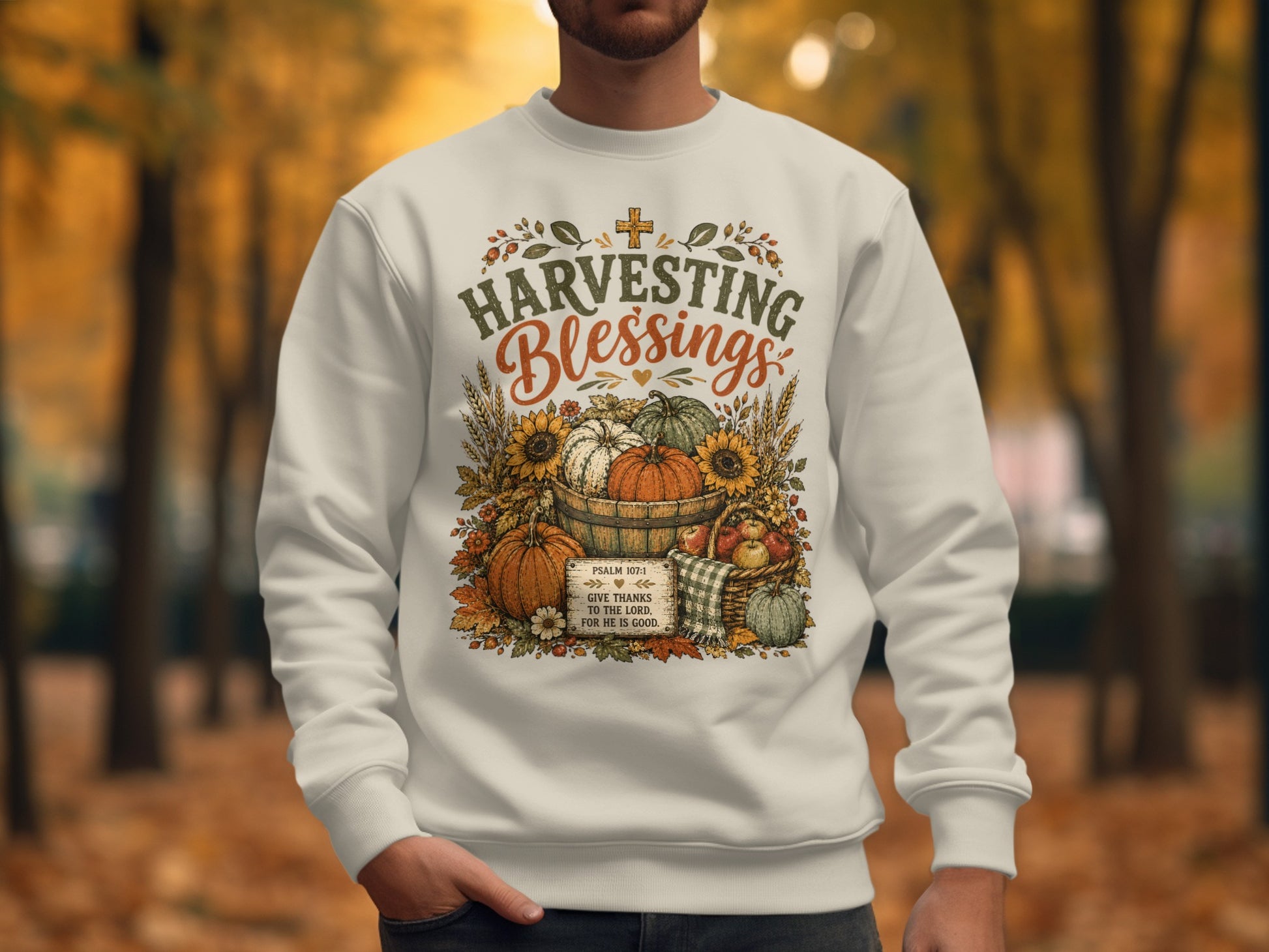 Cream sweatshirt with "Harvesting Blessings" text and autumn graphics.