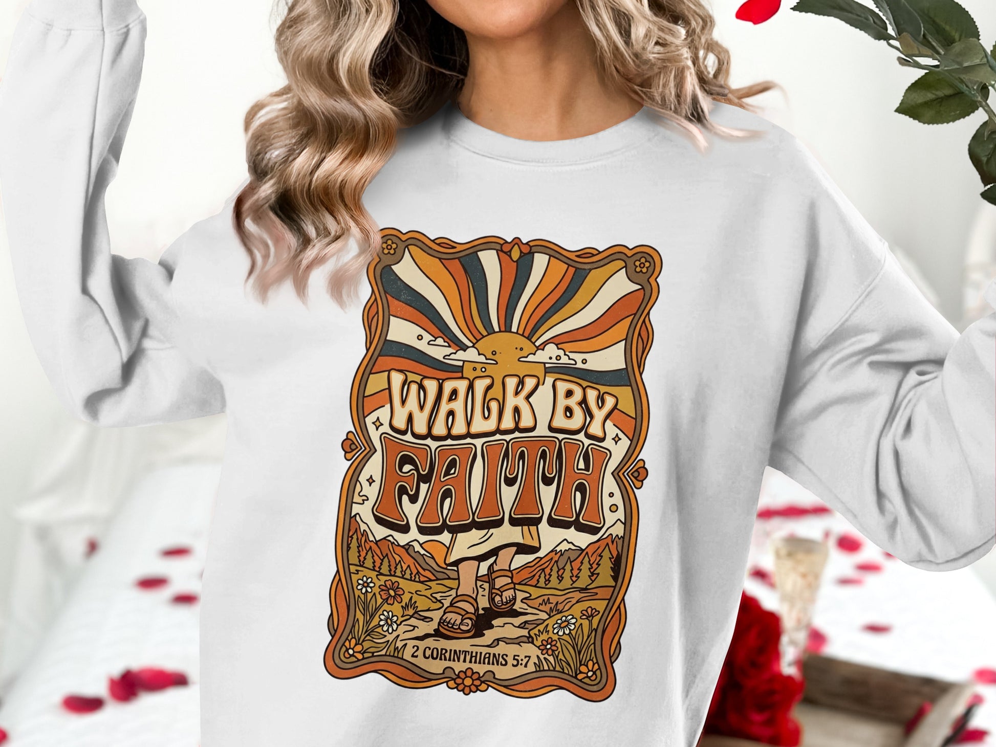 White sweatshirt with "Walk by Faith" graphic and floral/sun design.