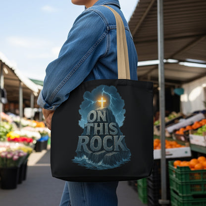 Tote bag with a cross on a rock, surrounded by lightning and waves, text reads "ON THIS ROCK".