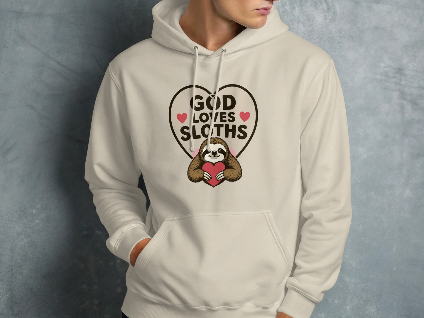Cream hoodie with graphic of sloth holding heart, reading "GOD LOVES SLOTHS".