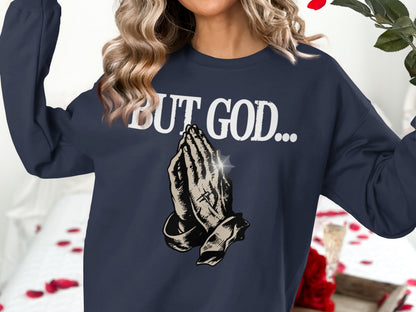Navy sweatshirt with praying hands and "BUT GOD..." text.