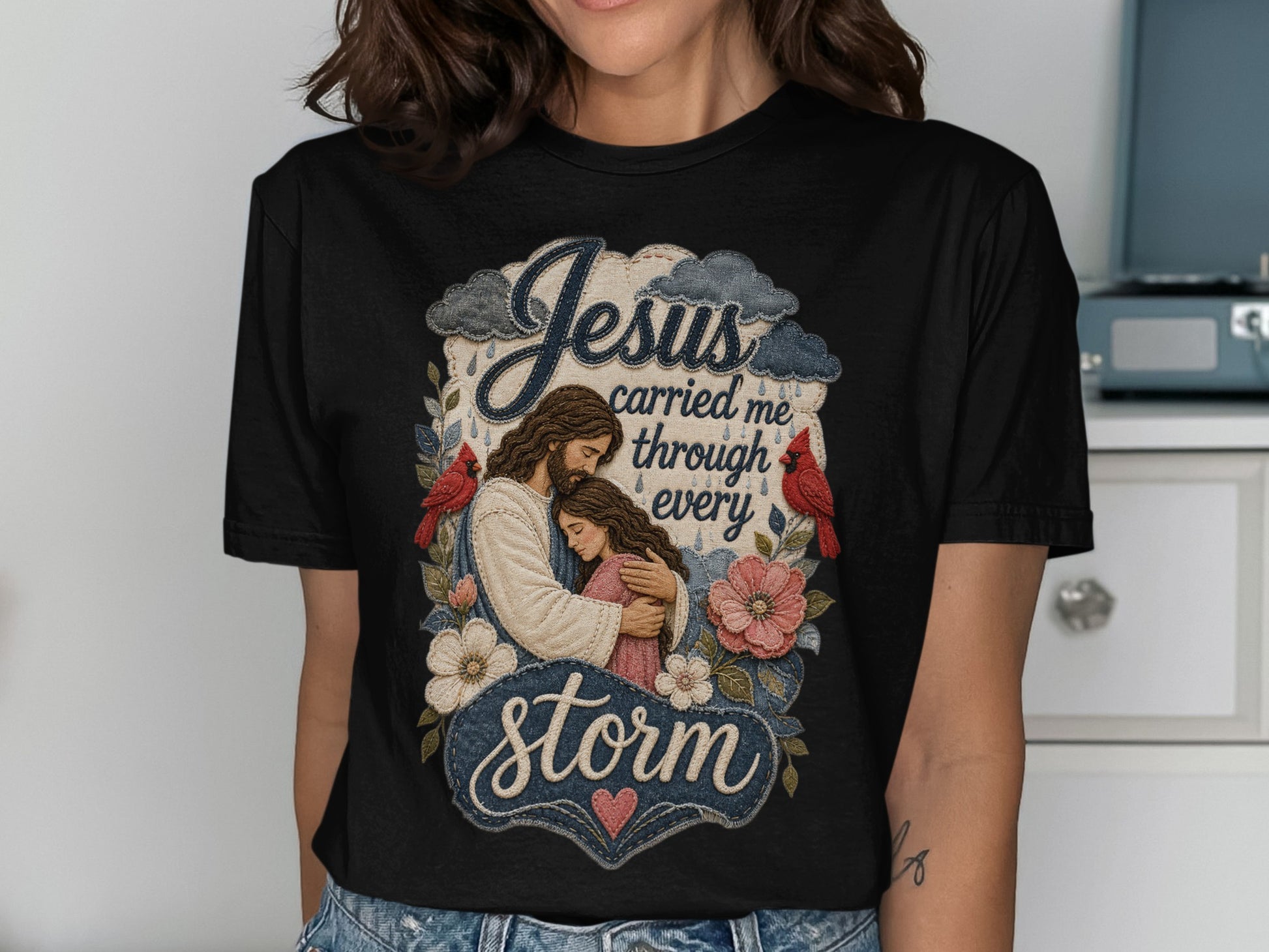 Jesus carried me through every storm graphic on black t-shirt.