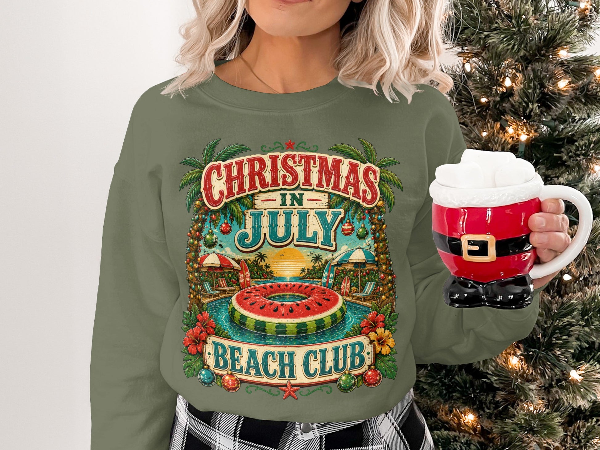 Green sweatshirt with "Christmas in July Beach Club" tropical holiday graphic.