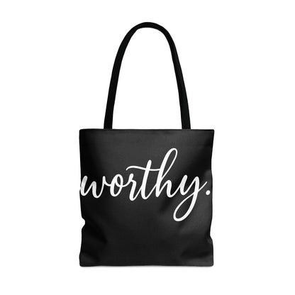 Black tote bag with white cursive text that reads "worthy."
