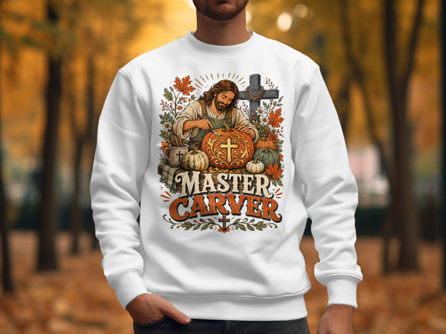 Jesus carving a pumpkin with "Master Carver" text on a white sweatshirt.