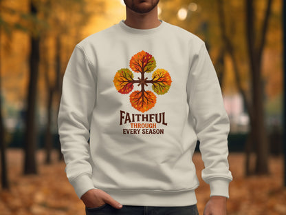 White sweatshirt with four colorful autumn trees forming a circle and the text "FAITHFUL THROUGH EVERY SEASON."