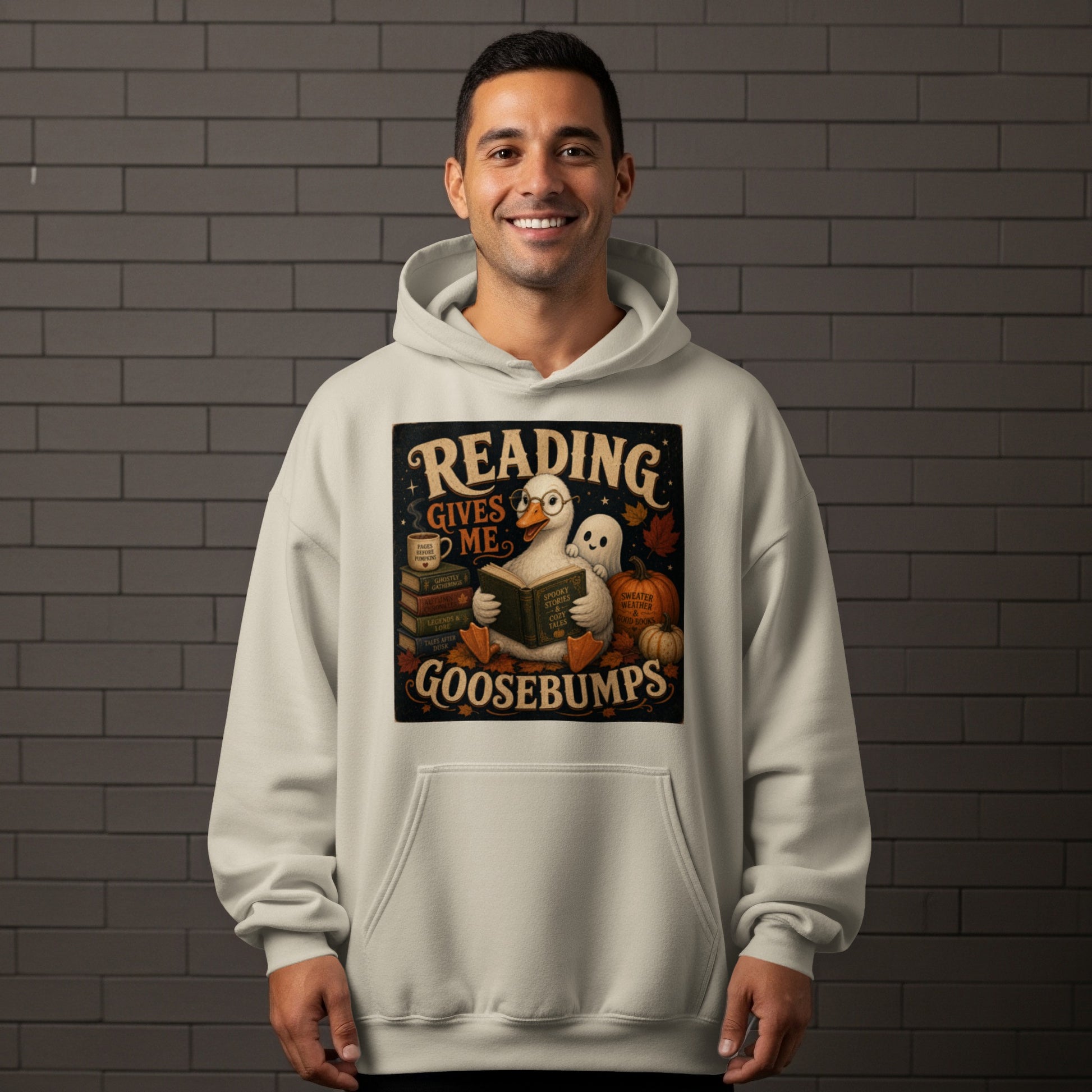 A goose wearing glasses reads a book, with a ghost and pumpkins, stating "Reading Gives Me Goosebumps."