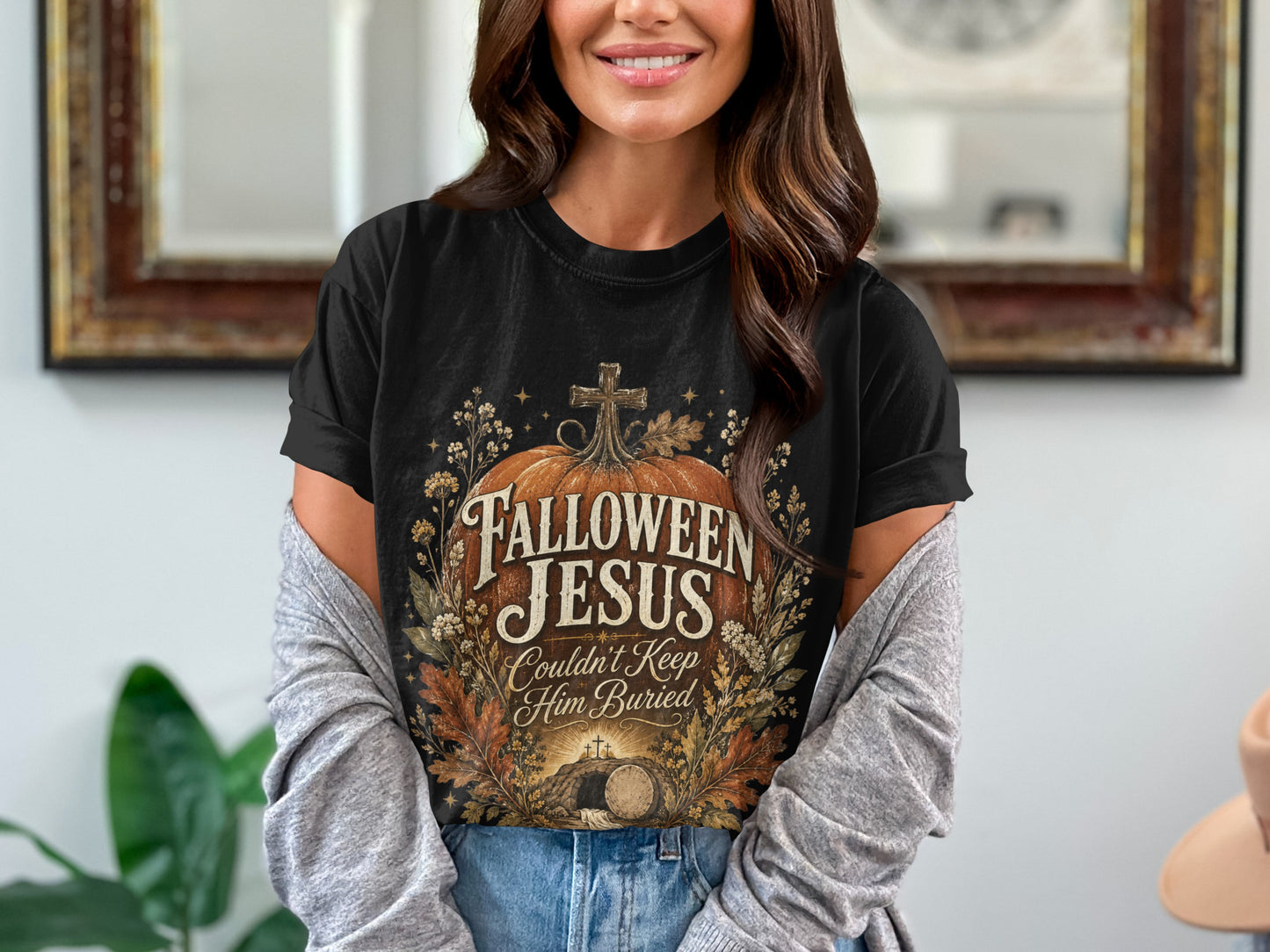 Black t-shirt with "Hallowen Jesus Couldn't Keep Him Buried" text and tomb graphic.