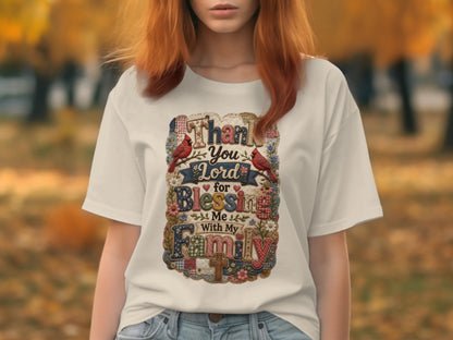 White t-shirt with "Thank You Lord for Blessing Me with My Family" text and floral, bird, and ribbon designs.