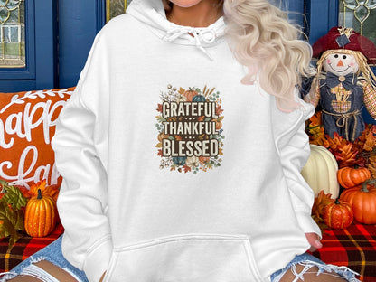 White hooded sweatshirt with "Grateful Thankful Blessed" floral autumn graphic.