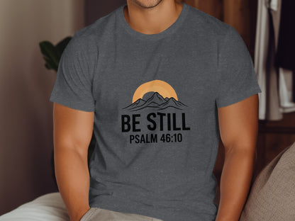 Dark grey t-shirt with "BE STILL PSALM 46:10" and mountain sunset graphic.