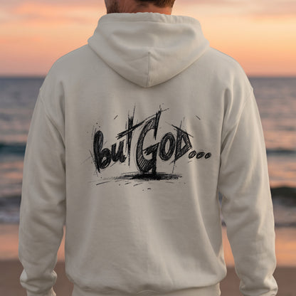 Cream hoodie with "but GOD..." text on the back, beach background.