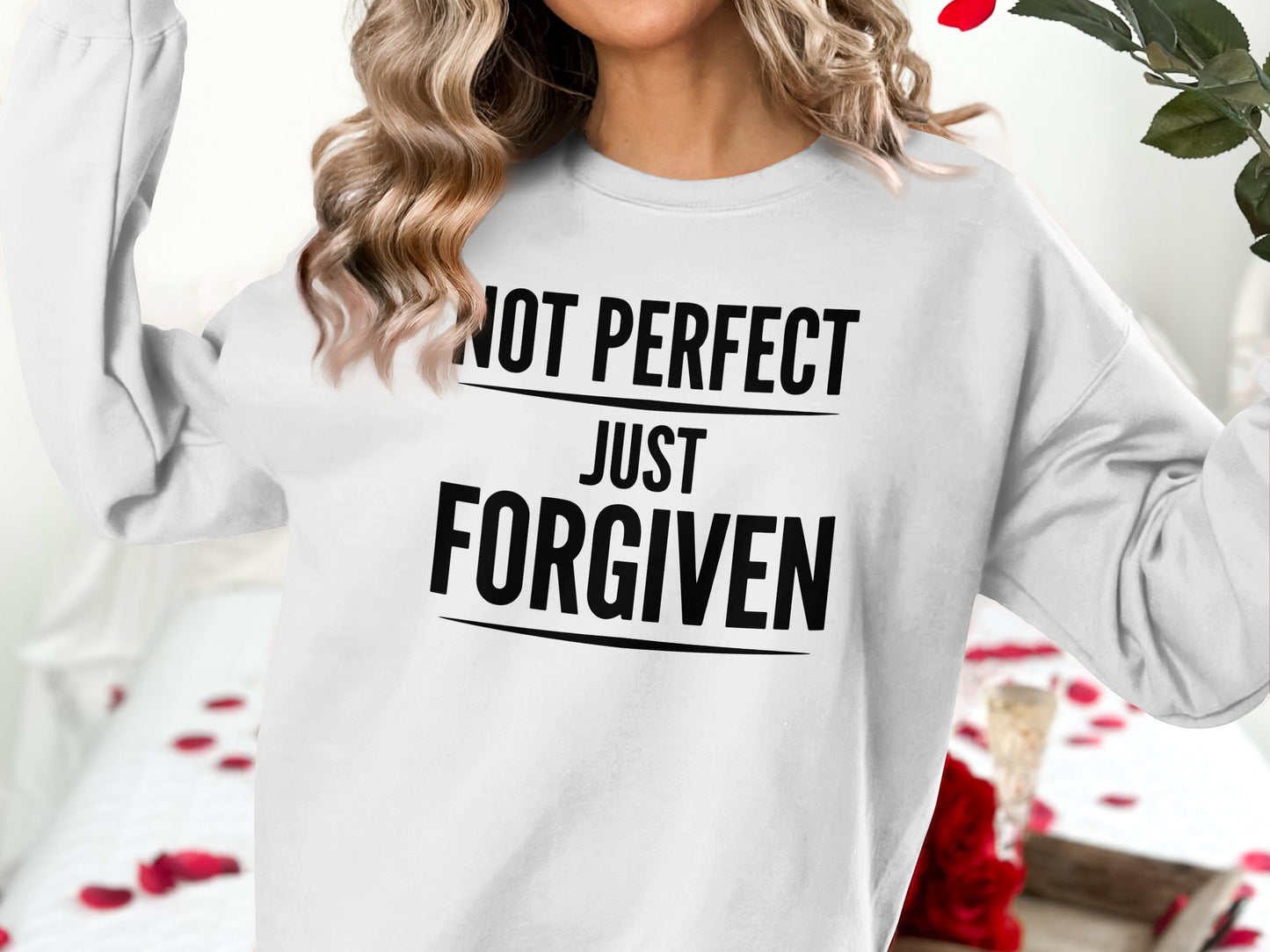 White sweatshirt with "NOT PERFECT JUST FORGIVEN" text.