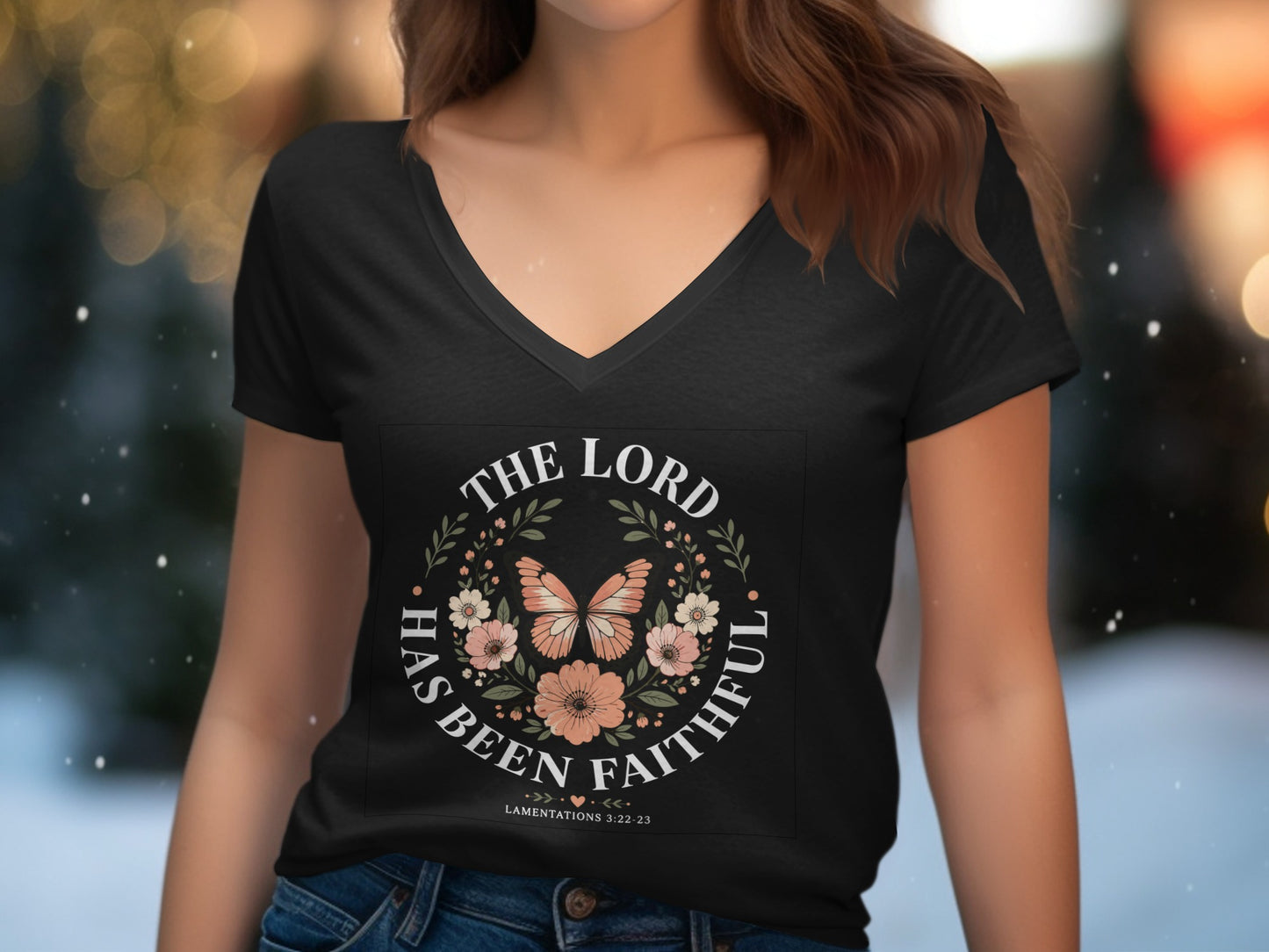 Black v-neck t-shirt with "The Lord Has Been Faithful" text and floral butterfly design.