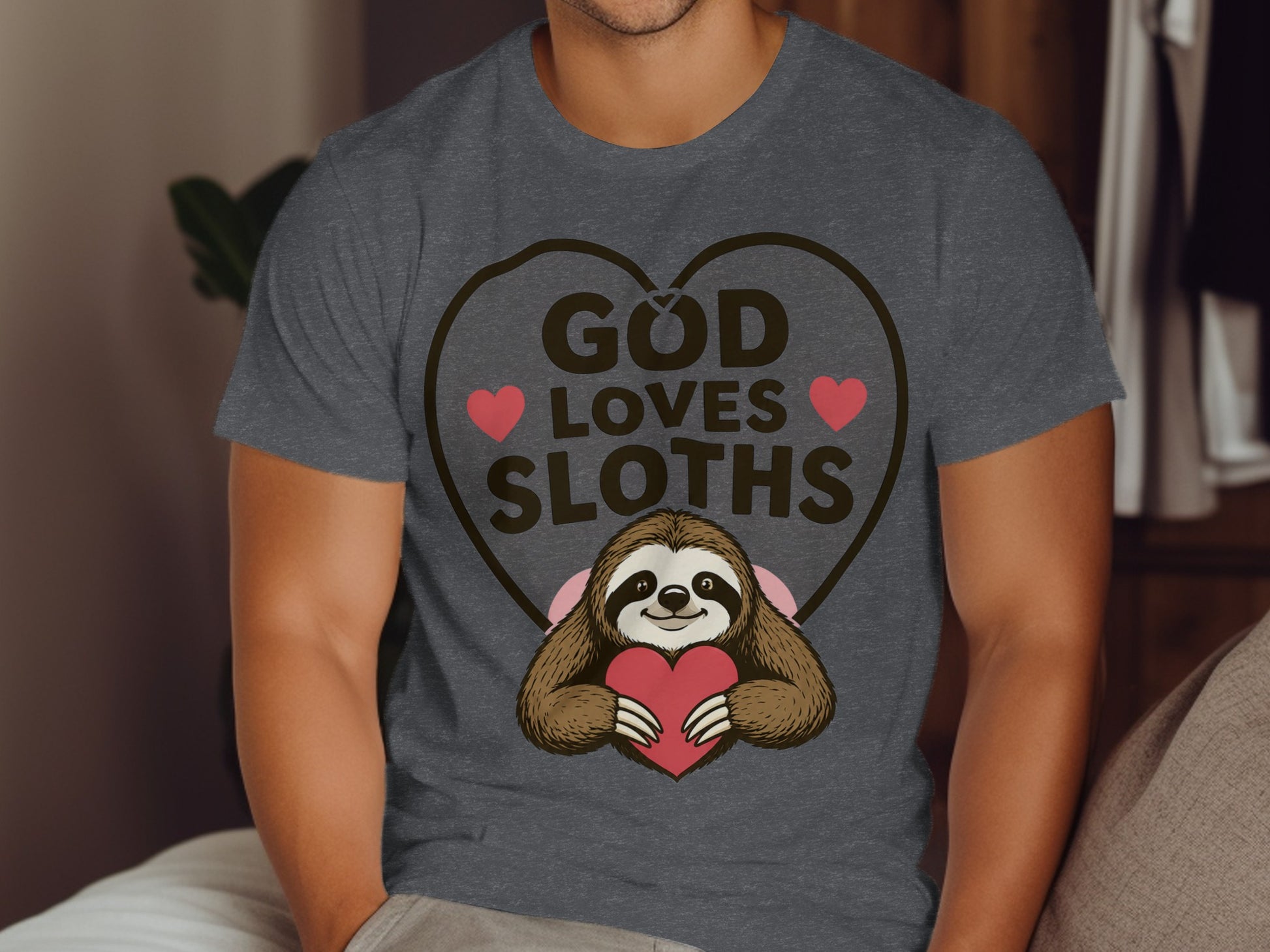 T-shirt with sloth holding heart, text "God Loves Sloths".