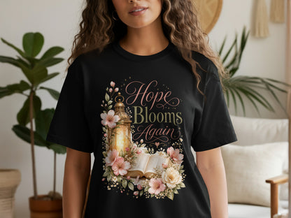 Black t-shirt with "Hope Blooms Again" text and floral design.
