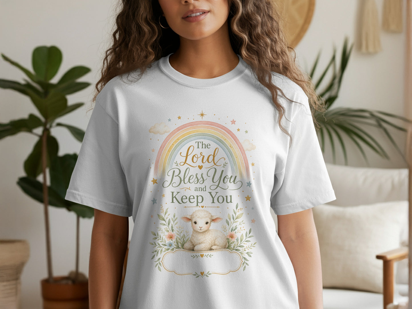 White t-shirt with a rainbow, lamb, and text: "The Lord Bless You and Keep You".