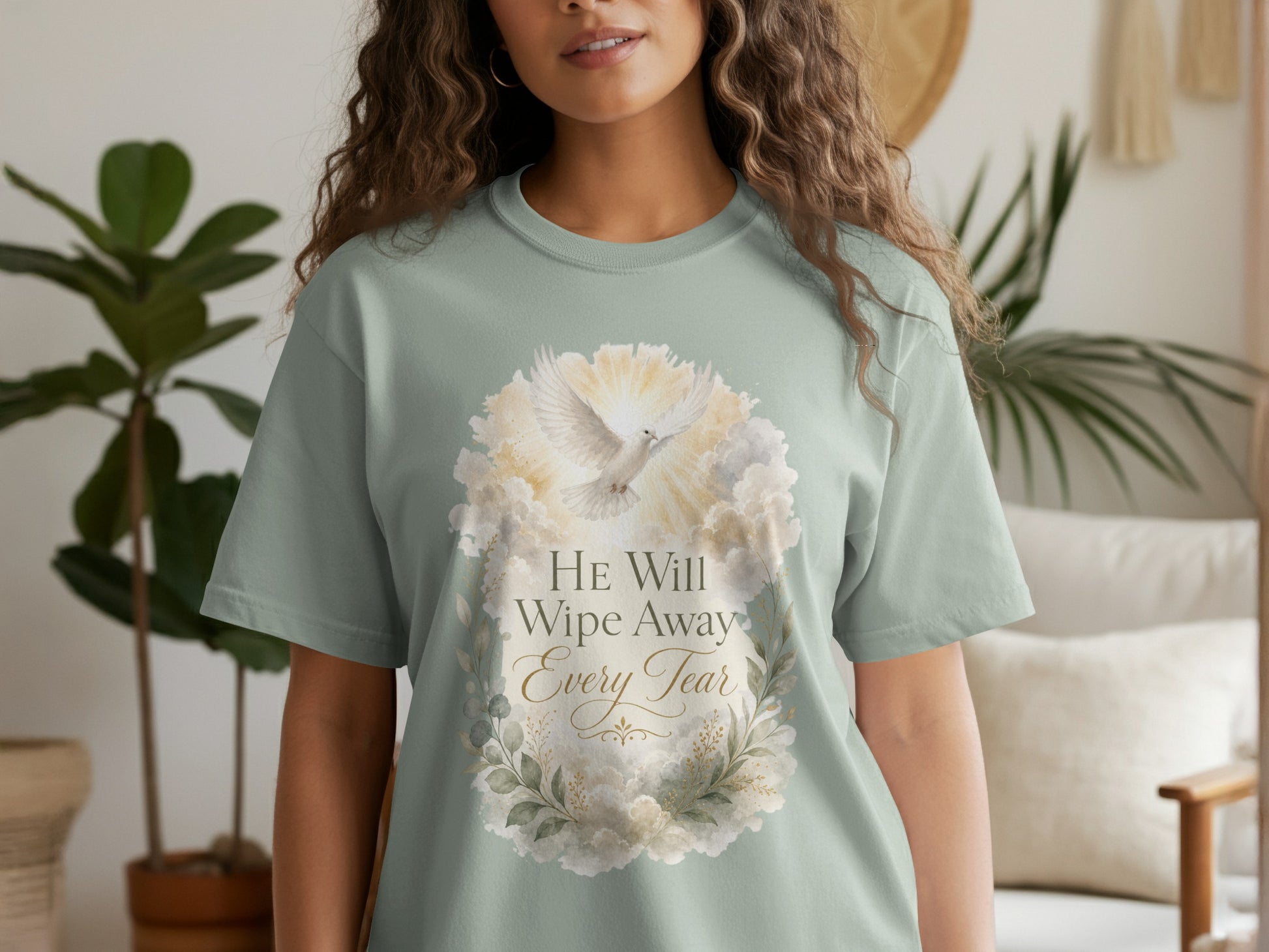 Mint green t-shirt with dove and floral design, says "HE Will Wipe Away Every Tear".