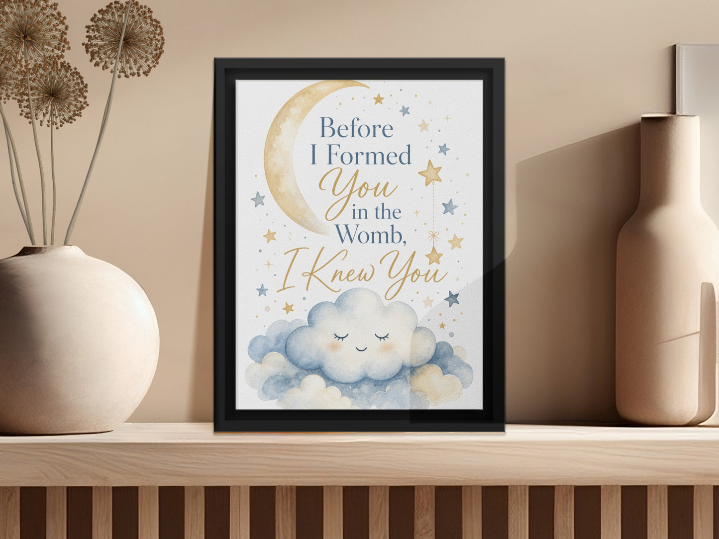 Framed print with text "Before I Formed You in the Womb, I Knew You" and watercolor clouds, moon, and stars.