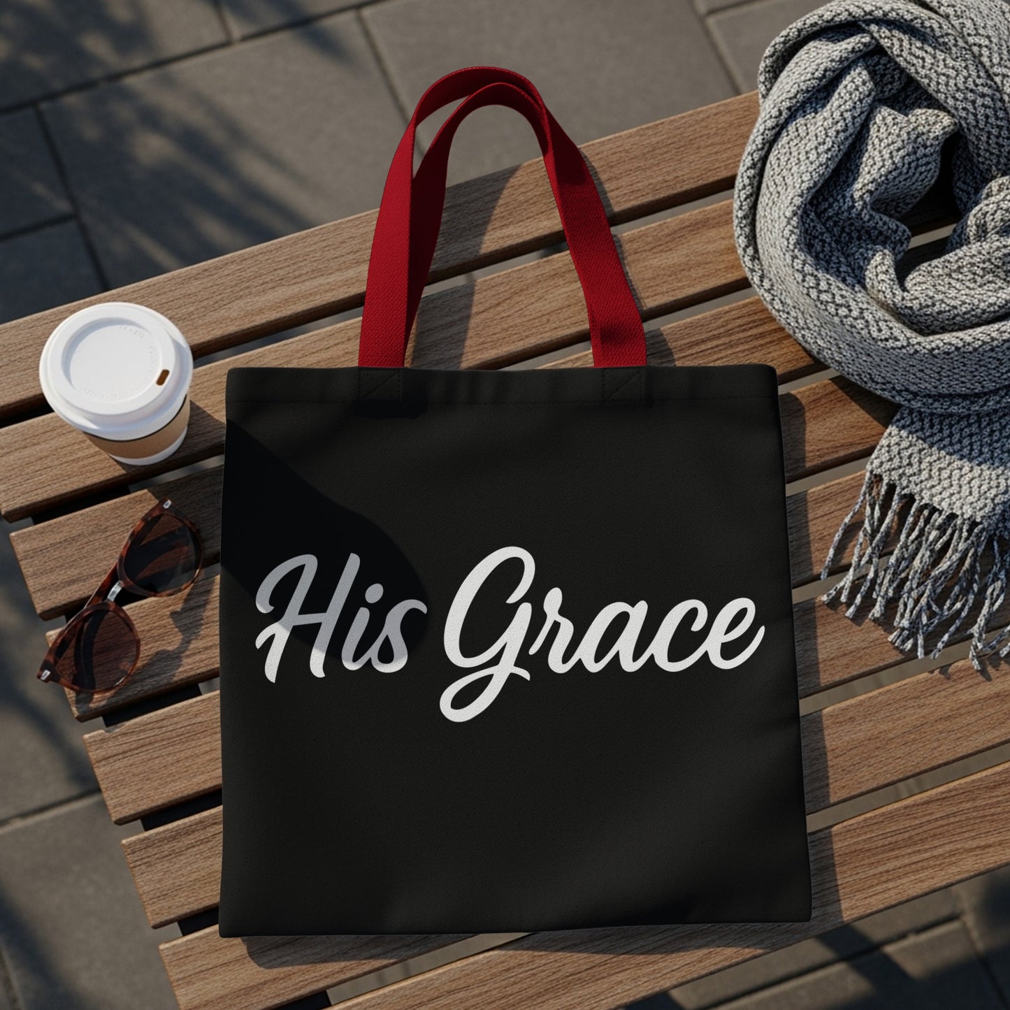 Black tote bag with red handles and "His Grace" text.