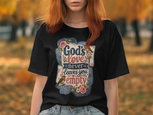 Black t-shirt with "God's love never leaves you empty" text and floral design.