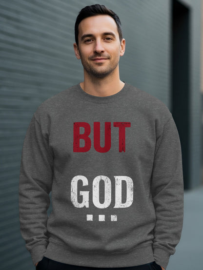 Man wearing gray sweatshirt with "BUT GOD" text.