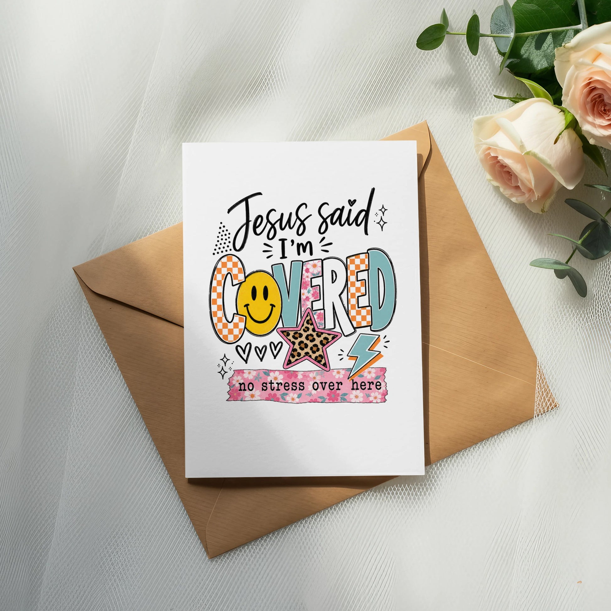 Card with "Jesus said I'm COVERED" text, smiley face, star, and floral design.