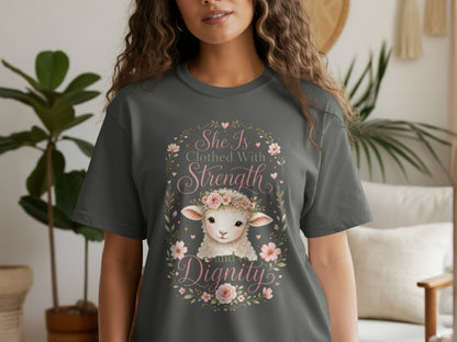 Dark grey t-shirt with a lamb, flowers, and the text "She Is Clothed With Strength and Dignity."