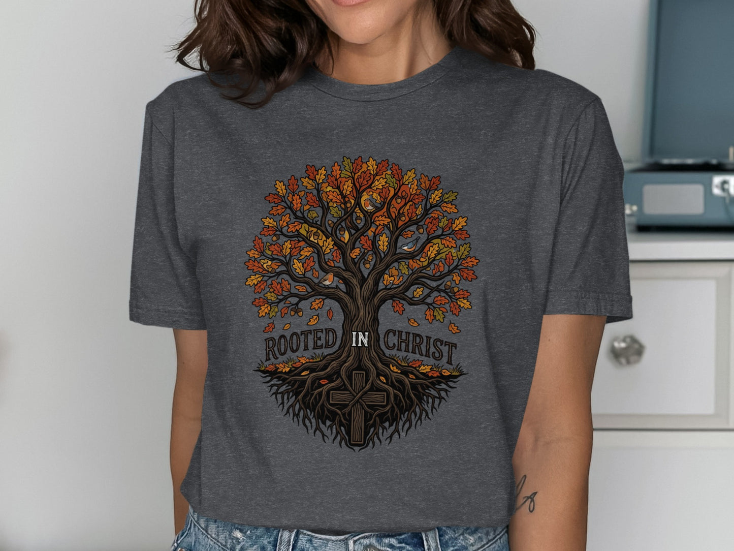 Dark gray t-shirt with a colorful tree and "Rooted in Christ" text.