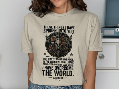 T-shirt with shield, wings, and biblical quote "I have overcome the world."