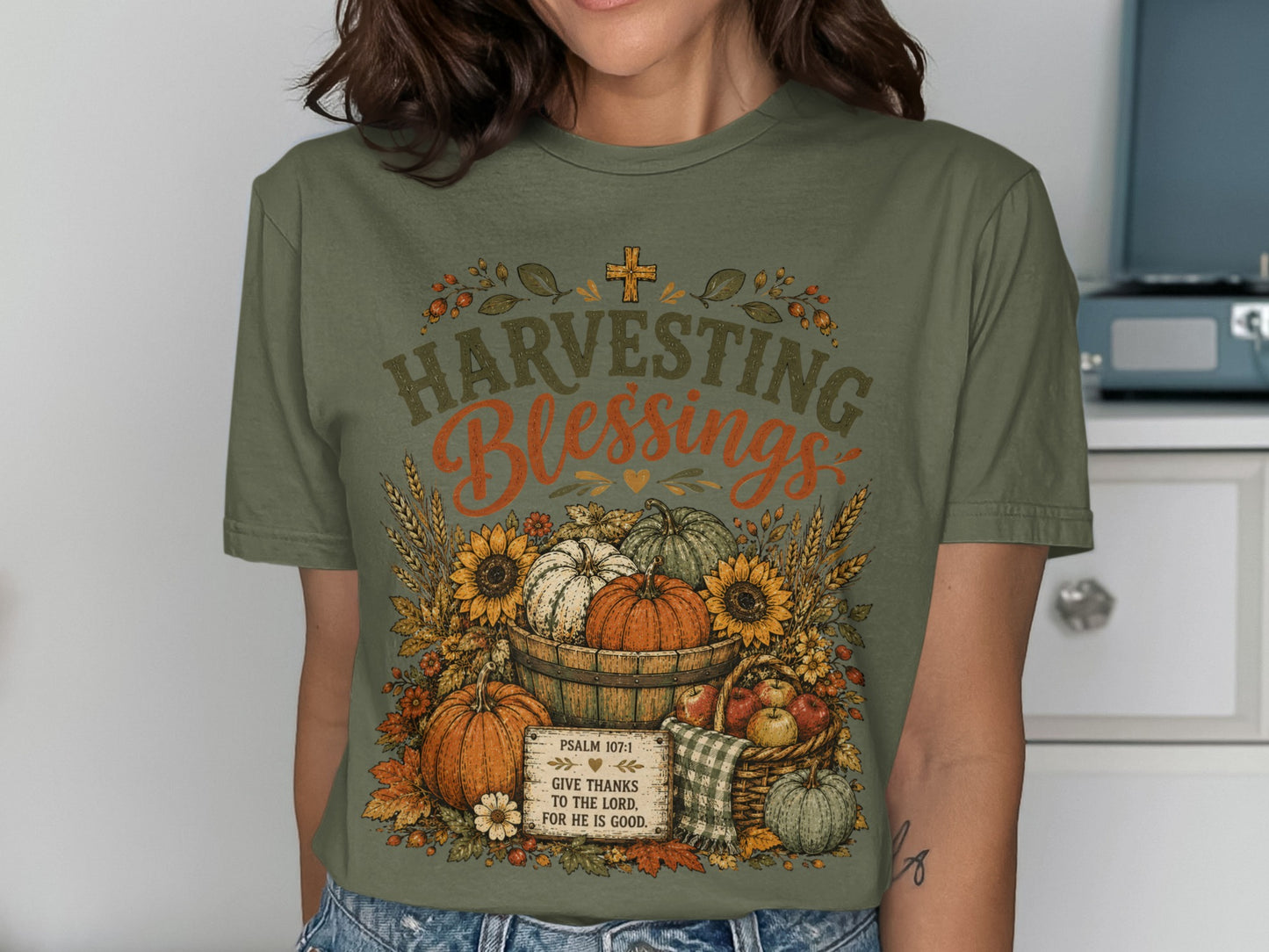 Green t-shirt with "Harvesting Blessings" and biblical text over pumpkins and fall foliage.