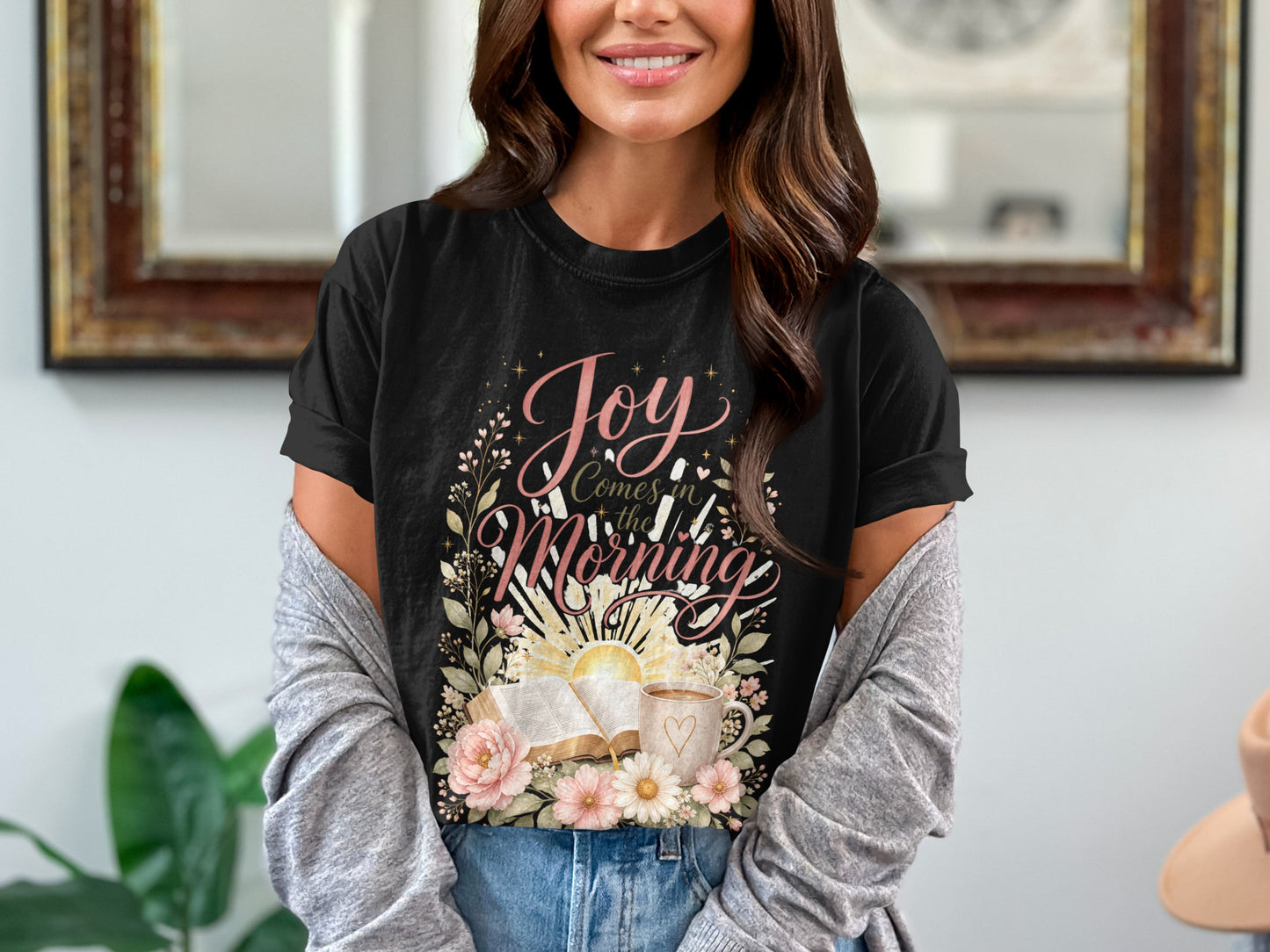 Black t-shirt graphic with "Joy Comes in the Morning" text, open Bible, and flowers.