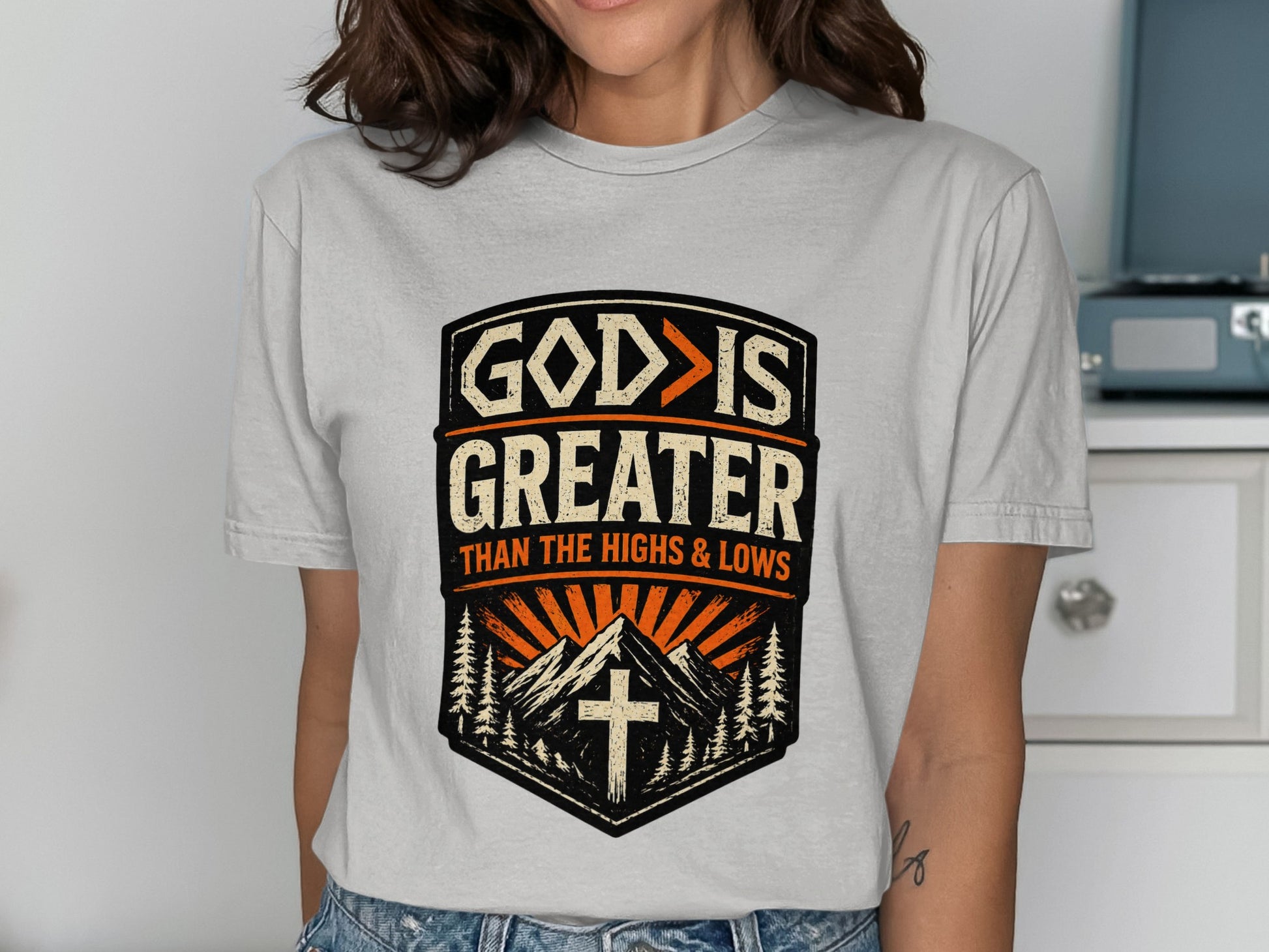 "God is greater than the highs and lows" t-shirt design with mountains.