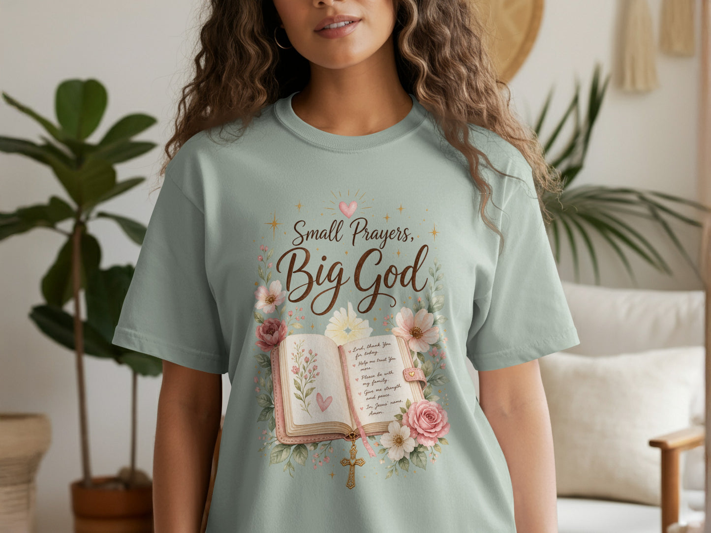 Light green t-shirt with "Small Prayers, Big God" text, an open book, and floral design.