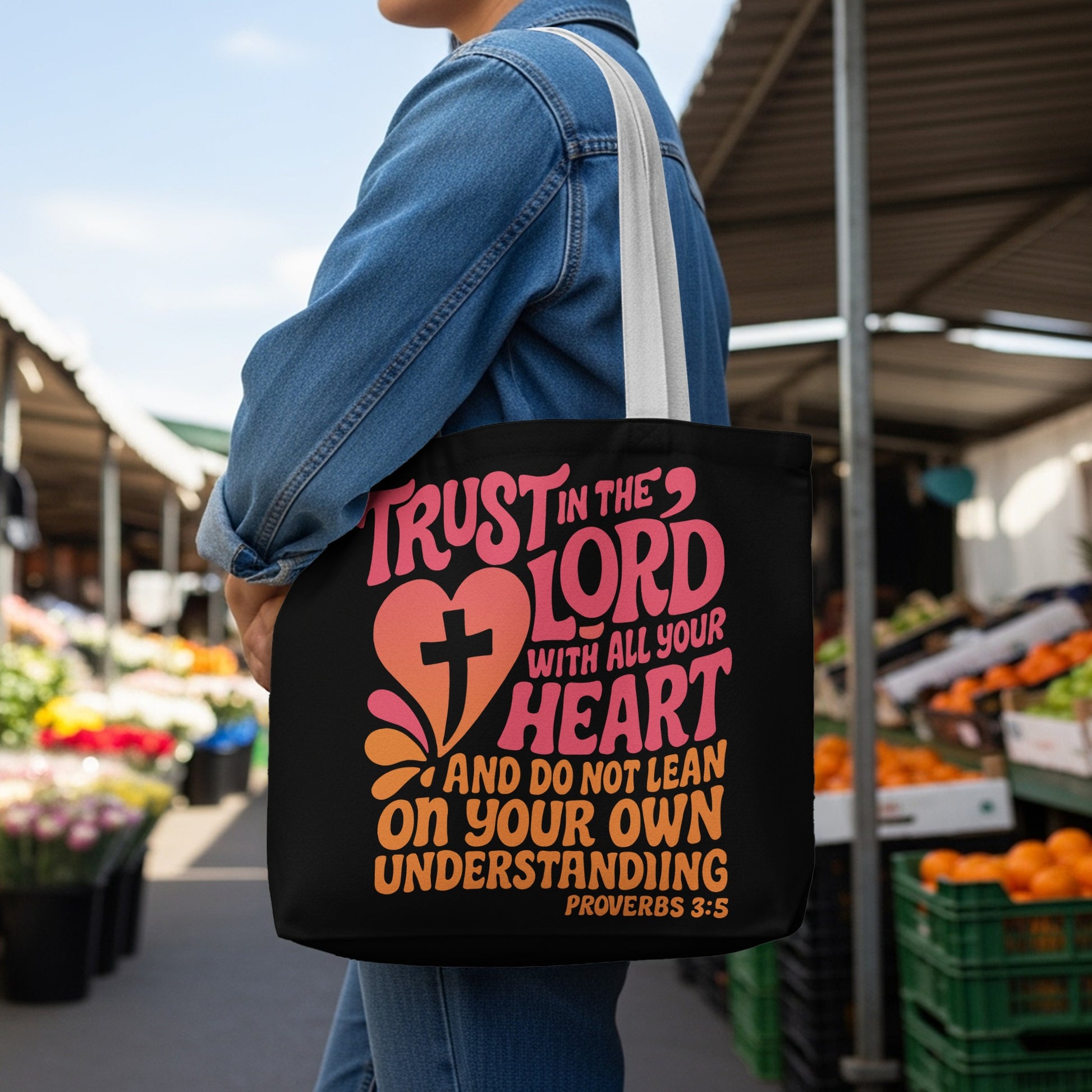 Black tote bag with "Trust in the Lord" scripture design and a cross.